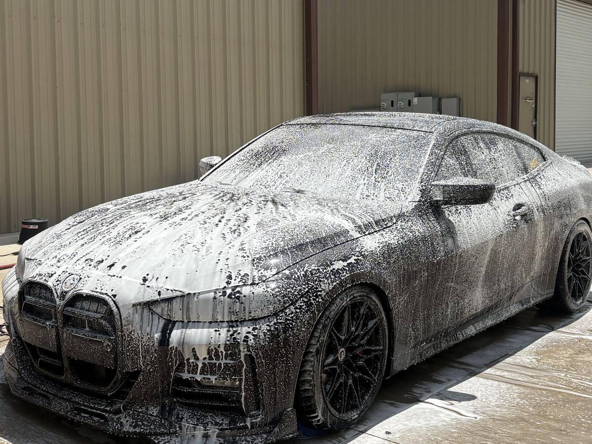 BMW 4 Series Gran Coupe covered in thick foam during a contact wash