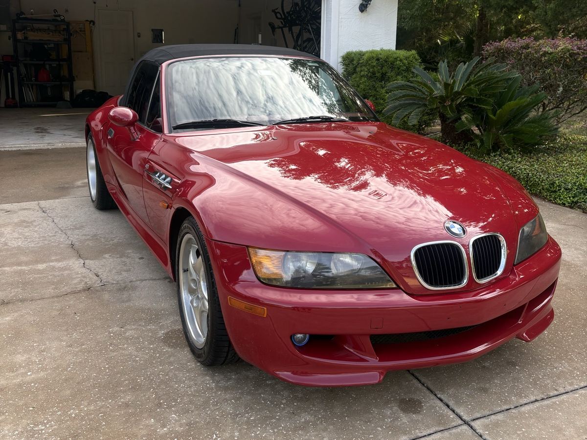 Red BMW Z3 roadster in a driveway after an exterior detail, paint glossy