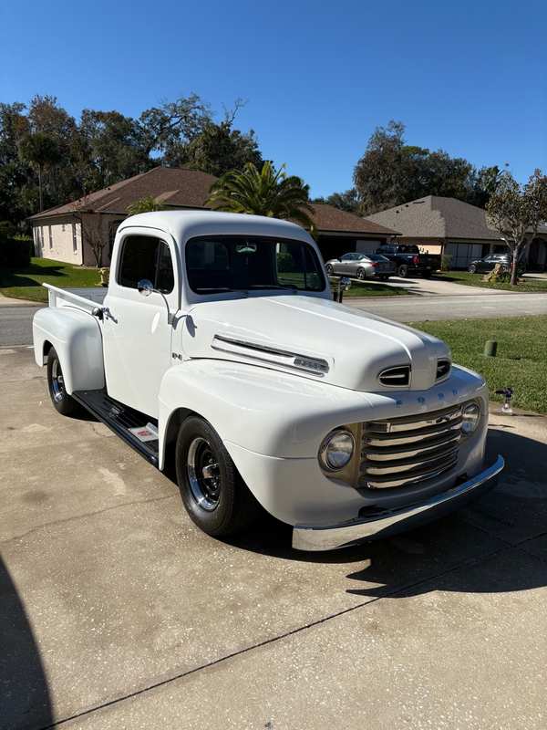 White classic Ford F-1 pickup detailed and parked in a driveway
