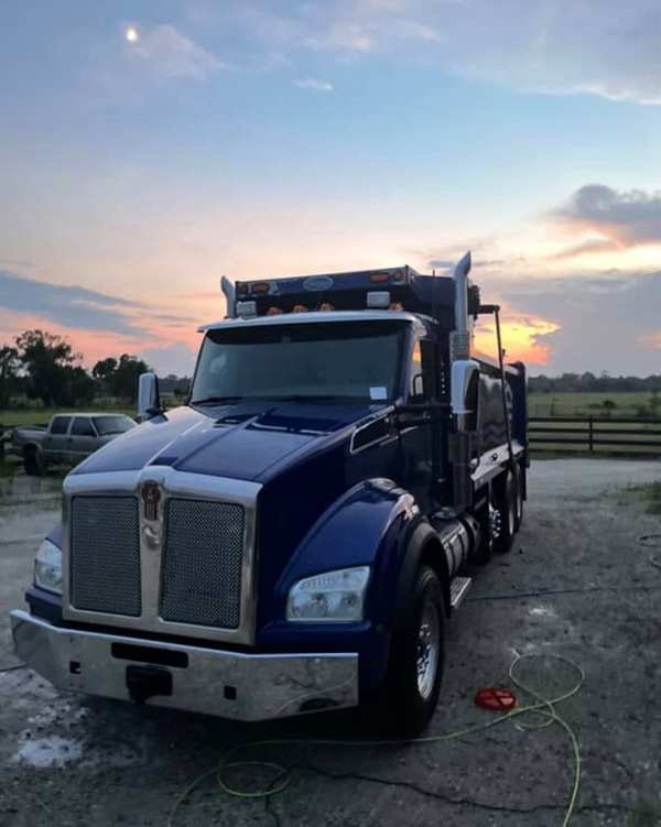 Navy Kenworth dump truck detailed at sunset — commercial vehicle work