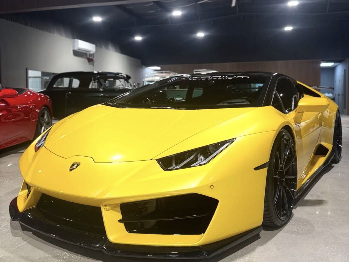 Yellow Lamborghini Huracán front three-quarter in a showroom after detailing
