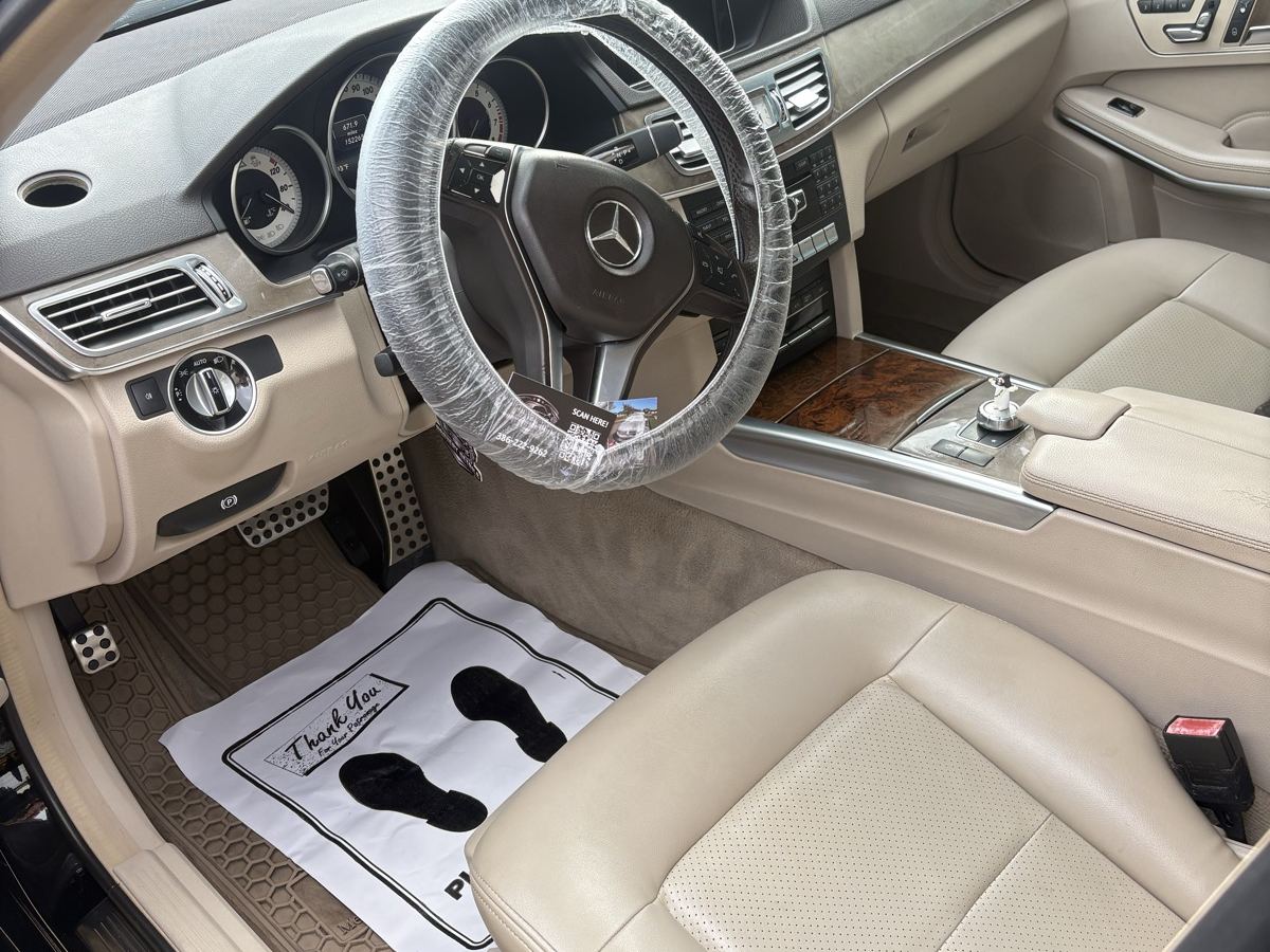 Mercedes cabin after an interior detail — tan leather cleaned, wheel wrapped, paper mat down