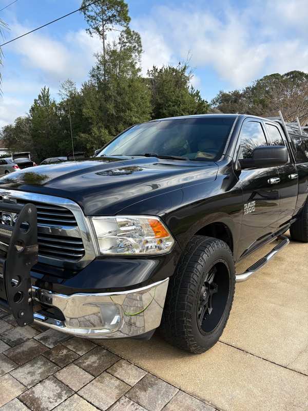 Black Ram 1500 pickup after an exterior detail, grille and wheels cleaned