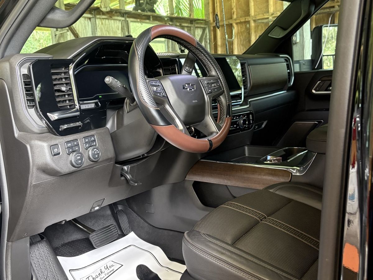 The same Silverado cabin after detailing — liner clean, leather and wood trim wiped, paper mat down