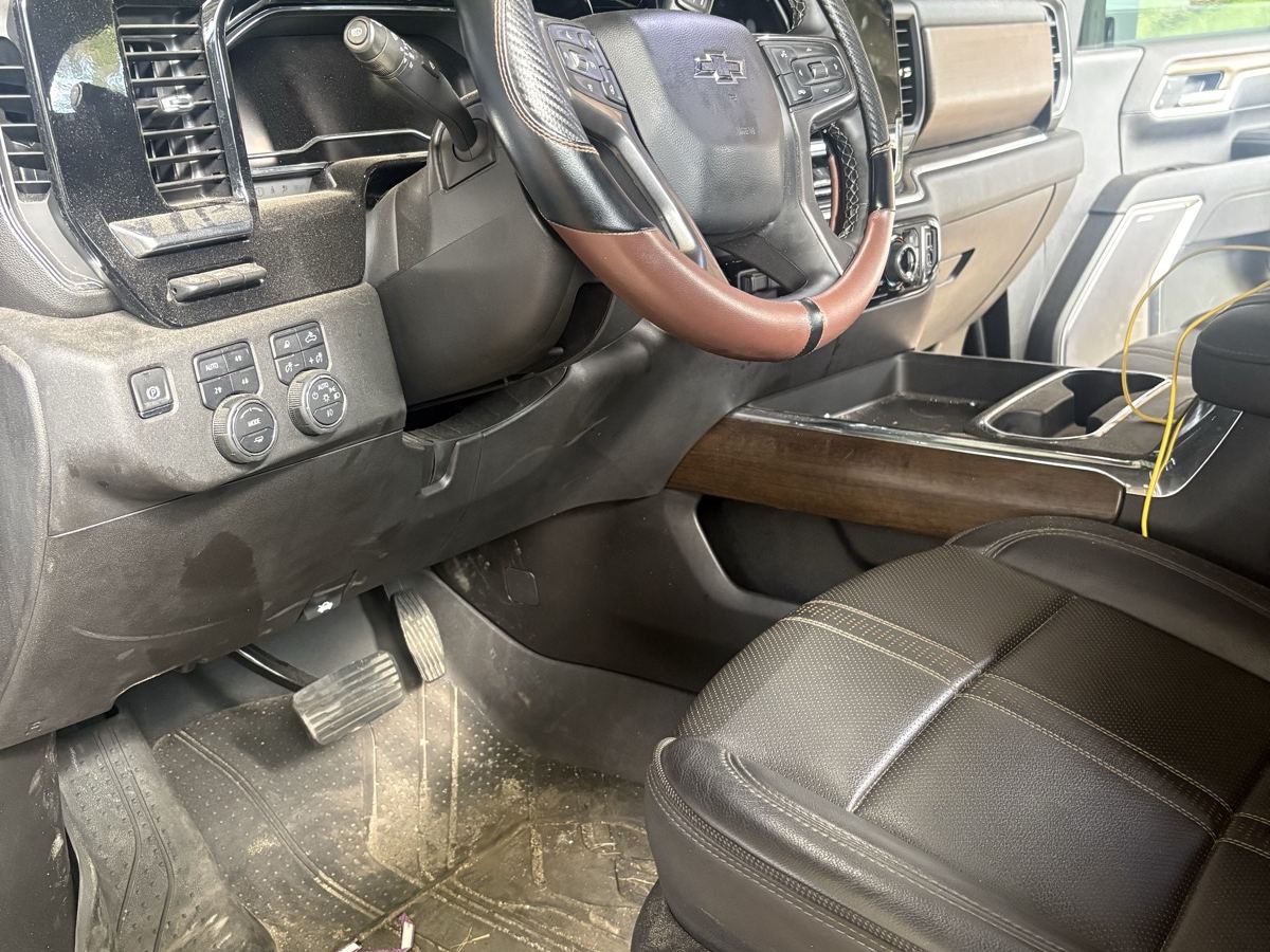 Silverado High Country cabin before detailing — muddy floor liner and dusty dash