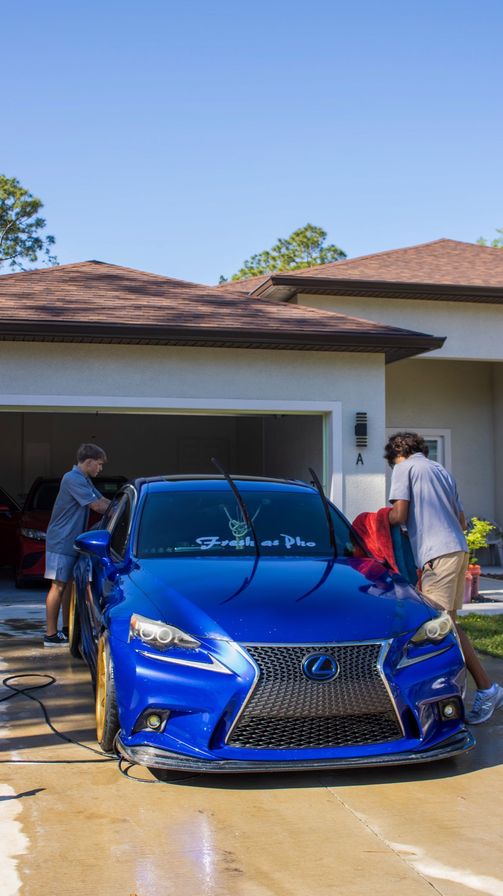 Bravery Details detailing a blue Lexus IS in a residential garage