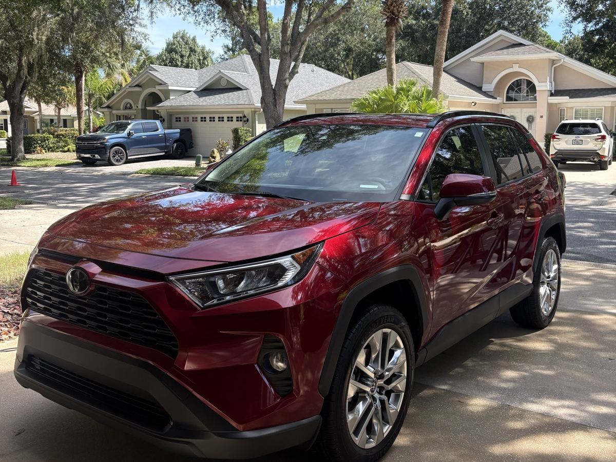 Red Toyota RAV4 detailed on a Palm Coast driveway