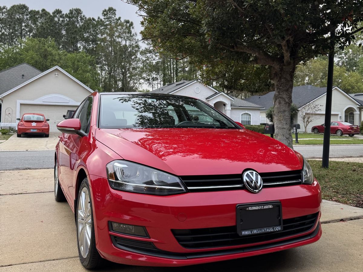 Red Volkswagen Golf detailed in a driveway